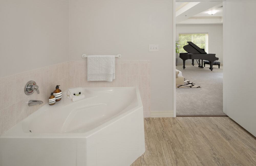 University House Issaquah retirement community apartment bathroom with large bathtub