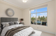 Bright bedroom with view of outdoor patio at the Aljoya Mercer Island retirement community in Mercer Island, ideal for serene senior living.