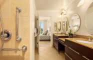 A spacious bathroom with double sinks and accessible grab bars at Aljoya Mercer Island retirement community in Mercer Island.