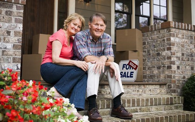 Happy older couple selling their home.
