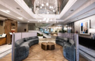 Elegant lobby with a beautiful chandelier and distinctive design, showcasing luxury at Aljoya Mercer Island retirement community in Mercer Island.