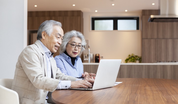 Senior Couple evaluating options on laptop