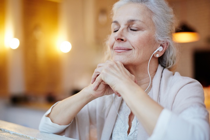 Woman relaxing by listening to music