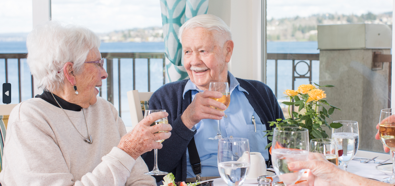 Two smiling residents enjoying lunch together