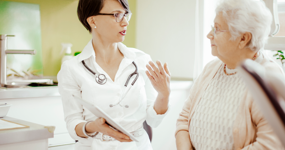 Docot talking to older woman patient.