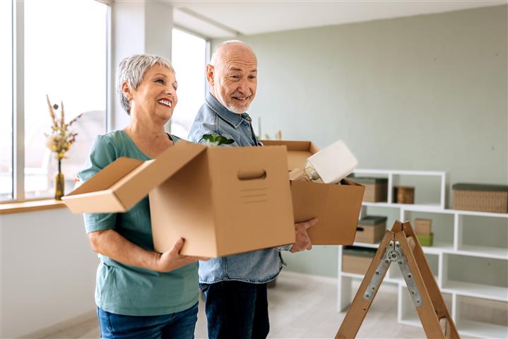 older couple packing boxes for a move